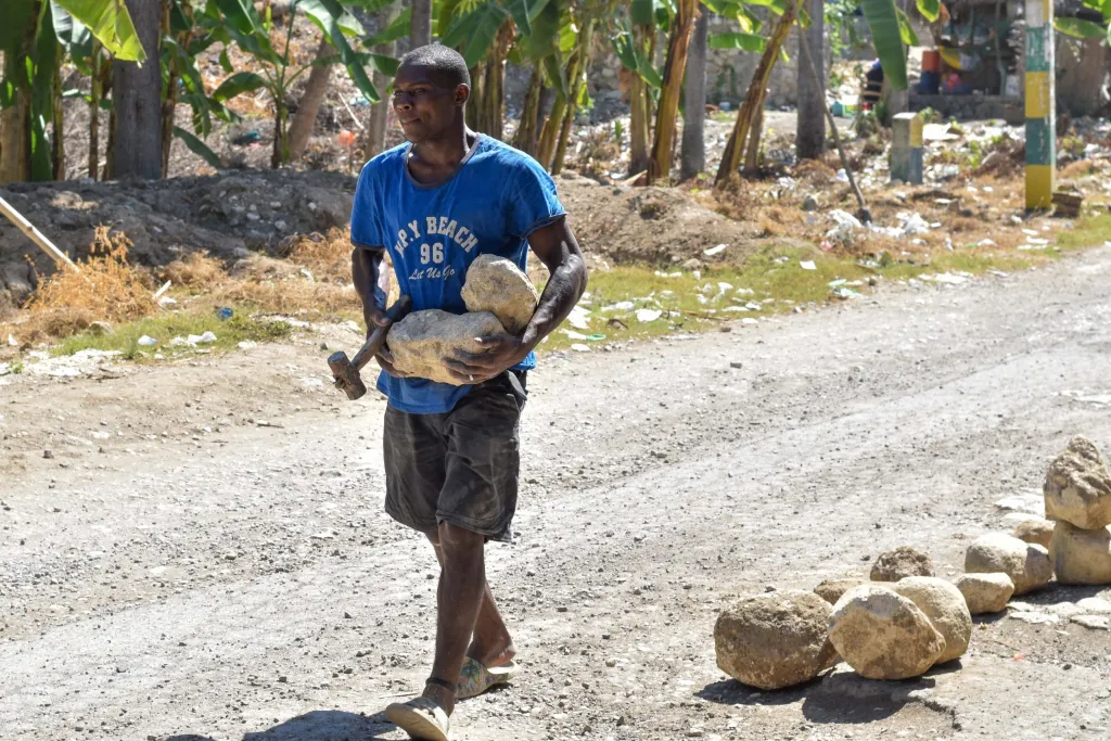 Andréluc Ocville / Andréluc Ocville, a Cayes-Jacmel native who has been fixing potholes on his own. Photo by Jean-Luc Saint-Fleur for The Haitian Times