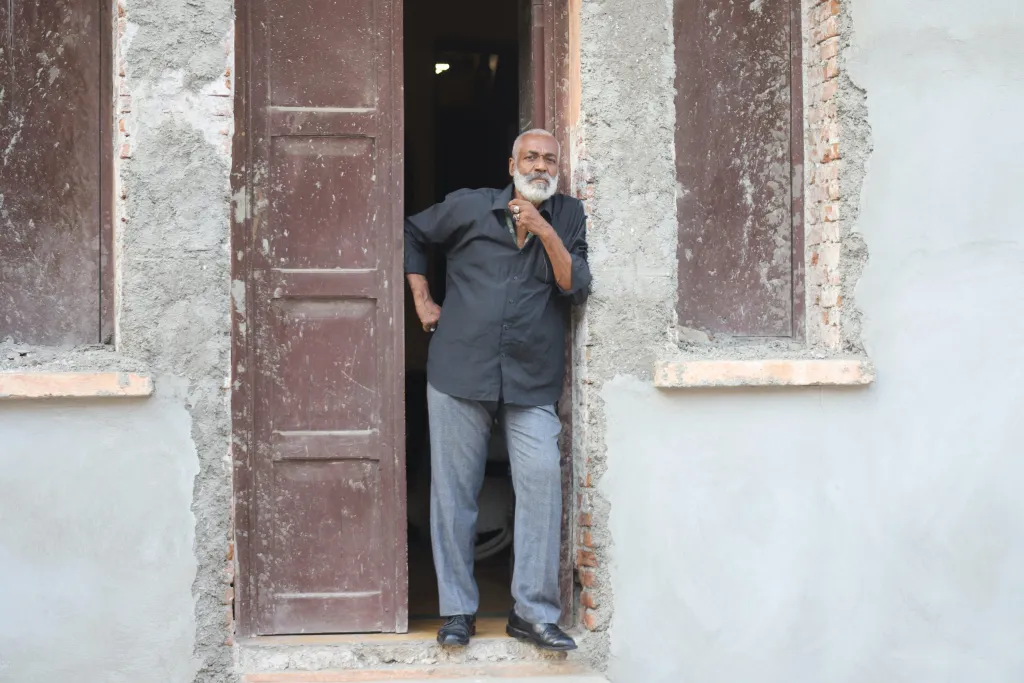 Eddy Lubin / On March 24, 2022, Eddy Lubin, an ISPAN chargé de mission, appears at the door to his house in Cap Haitian. Photo by Onz Chery for The Haitian Times.