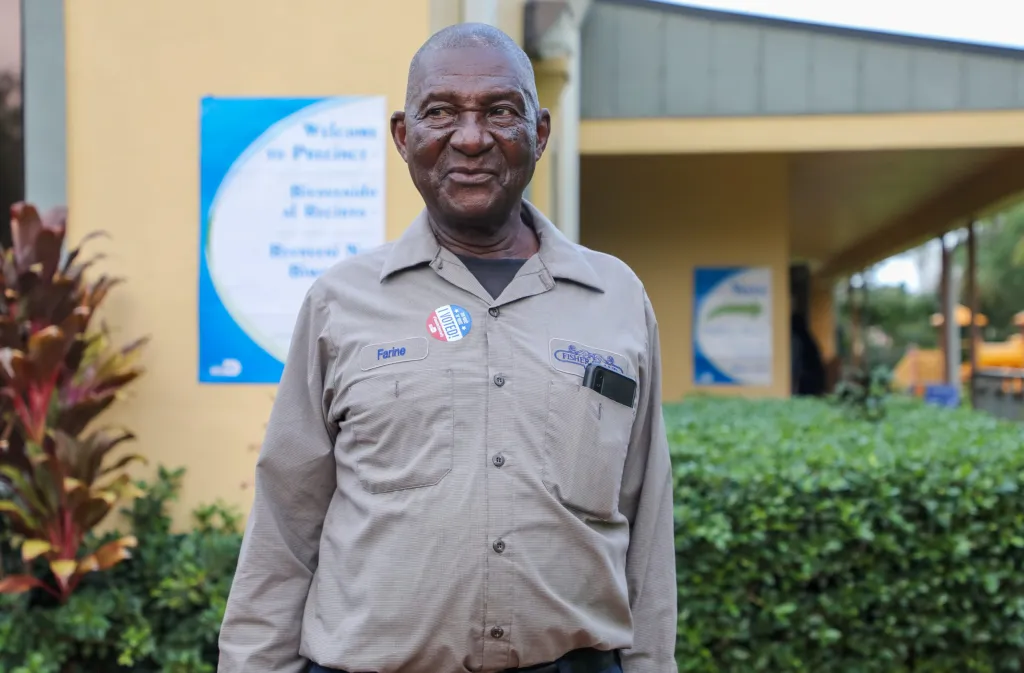 Joseph Farine / Outside the Haitian Evangelical Baptist Church, Joseph Farine displays his polling badge. On November 8, 2022, voters went to the polls to vote for Haitians in municipal, statewide, and federal contests in the 2022 congressional elections. Photo by (Haitian Times/Ashley Miznazi)