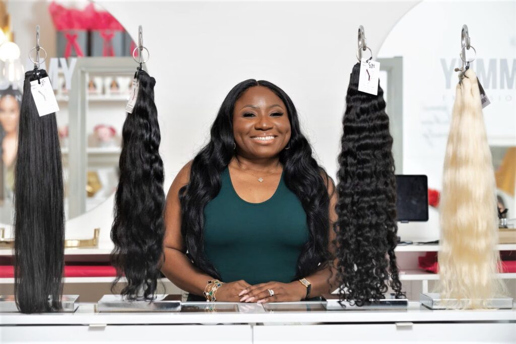 Yummie O. / Yummie O., founder and CEO of Yummy Extensions, is pictured on Nov. 9 at her Dallas shop. A Nigerian entrepreneur founded Yummy Extensions, a luxury hair brand with retail locations in Dallas and Brooklyn, New York. Photo by (Ben Torres / Special Contributor)