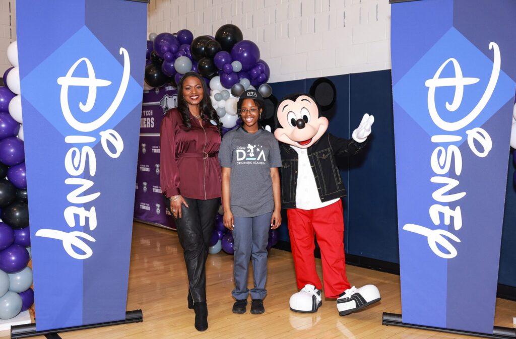 Disney Dreamers Academy Class / After being informed on national television on January 13, 2023, that she is one of 100 students chosen for this year's Disney Dreamers Academy at Walt Disney World Resort in Florida in March, Mickey Mouse and Disney Dreamers Academy executive champion Tracey Powell pose with Newark Tech (N.J.) high school student Mosope Aina. All 100 Dreamers' identities were also listed on a Times Square sign. Every year, the Walt Disney World Resort hosts the Disney Dreamers Academy, a mentoring program designed to support the aspirations of Black students and teenagers from marginalized groups. Photo by (ABC/Michael Le Brecht II)